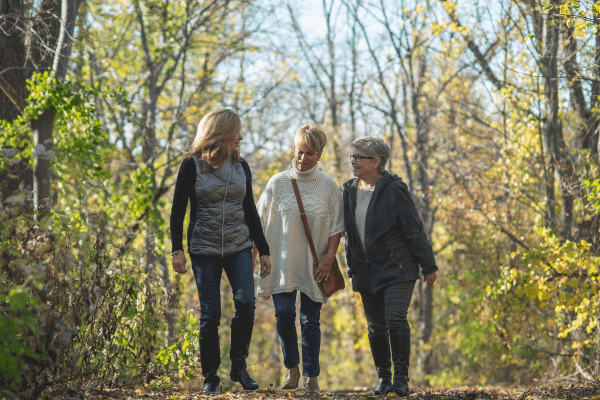 Women walking through a hiking trail in the forest