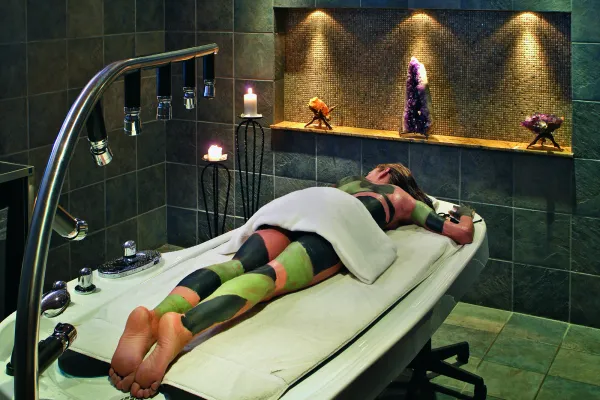 Woman receiving mud body treatment at Elements Spa.