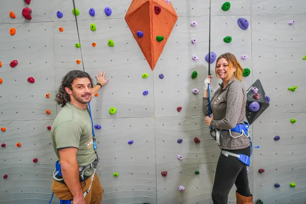 Two adults getting ready to rock climb.