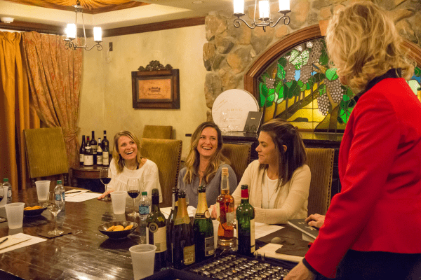 Group of three women do a wine tasting with wine sommelier, Susanne Wagner.