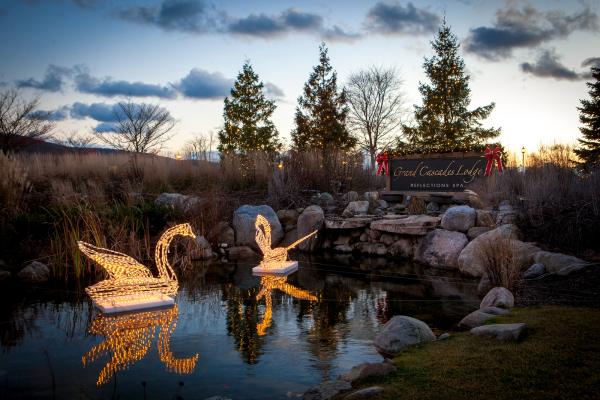 The pond in front of Grand Cascades in winter with holiday lights.