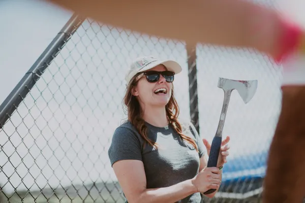 Women holding axe at axe throwing game