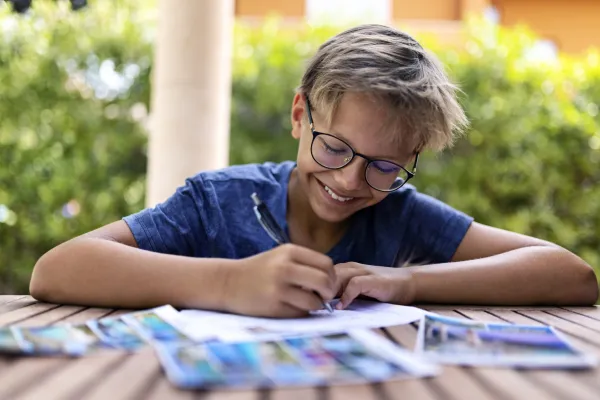 Child writing postcards