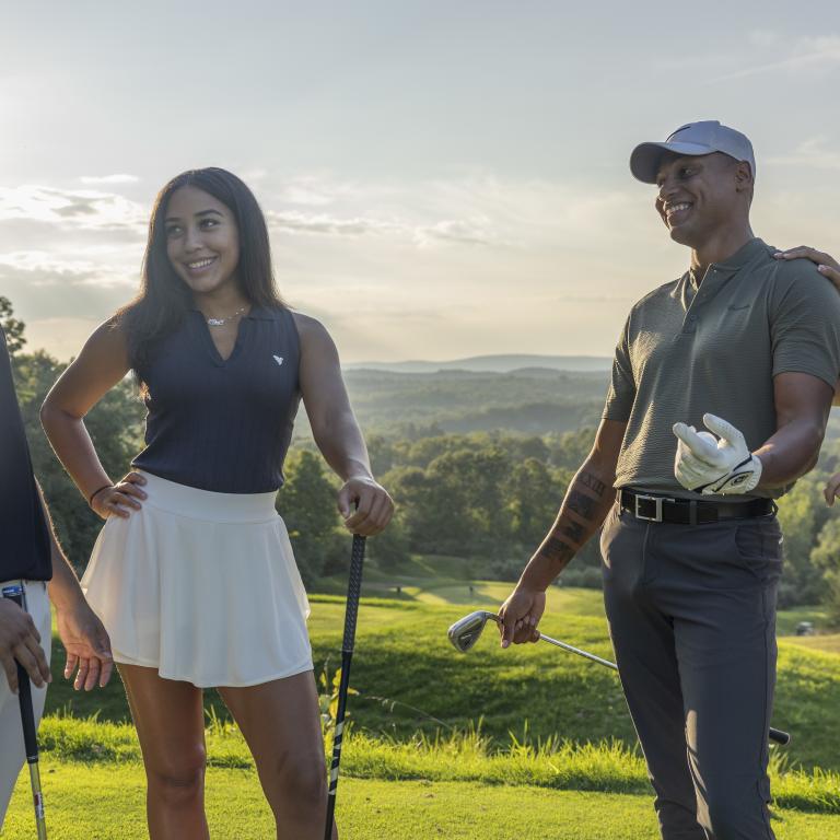 Two women and two men stand together on golf course, 