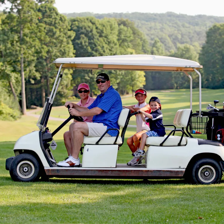 Parents with their kids on a family friendly golf course at Crystal Springs Resort in New Jersey.