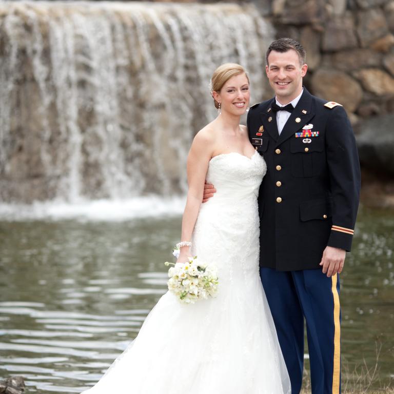 Bride and groom in front of waterfall