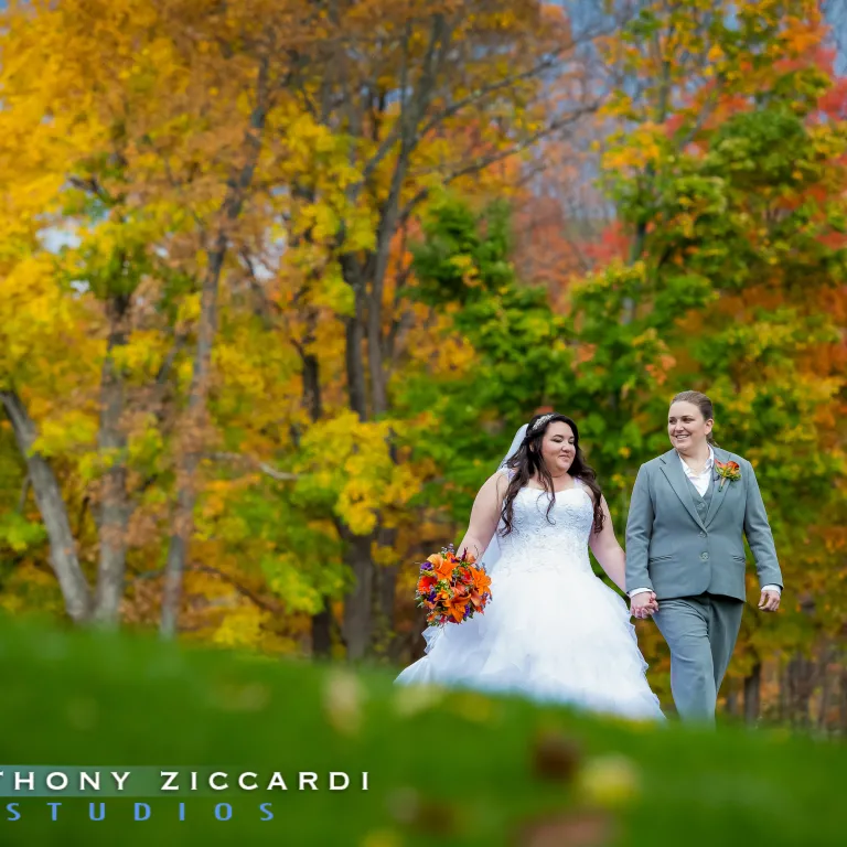 Brides holding hands on Black Bear Golf Course