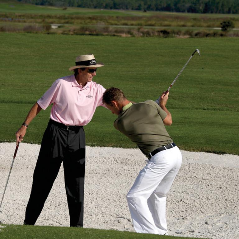 David Leadbetter teaching man how to golf at Crystal Springs Resort