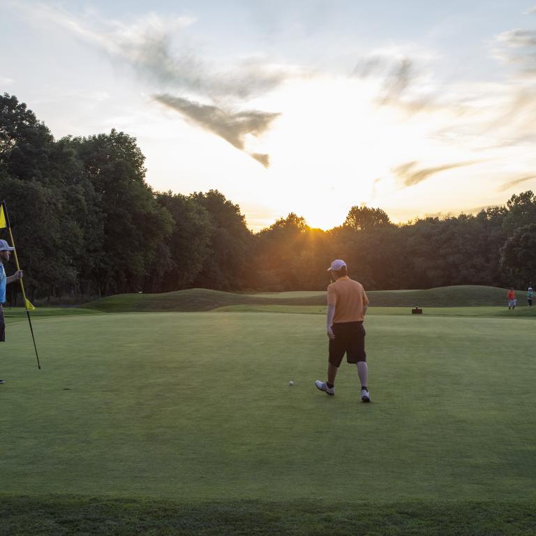 Two men on the putting green of Black Bear Golf Course