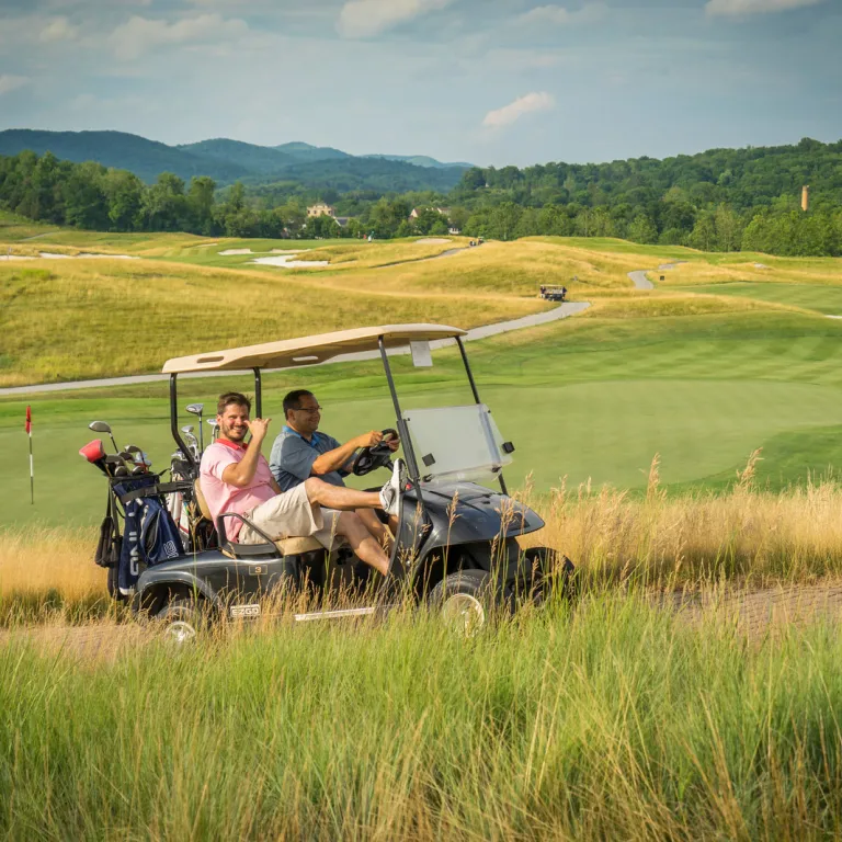 Guys riding on a golf cart at Ballyowen