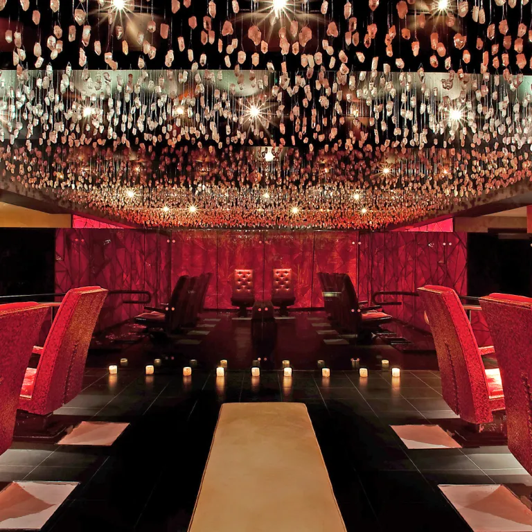 Crystal room at Reflections Spa featuring red chairs.