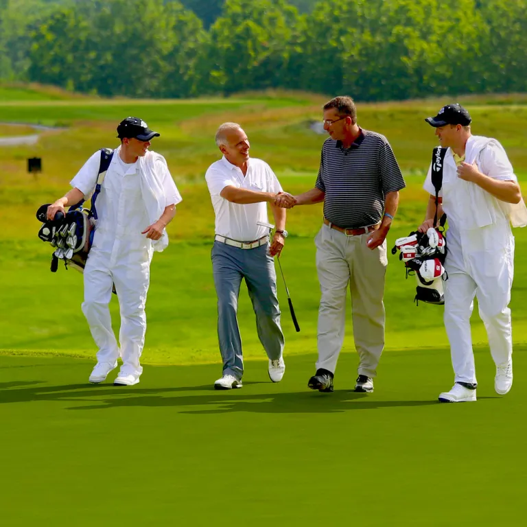 Golfers and Caddies at a golf resort close to New York City