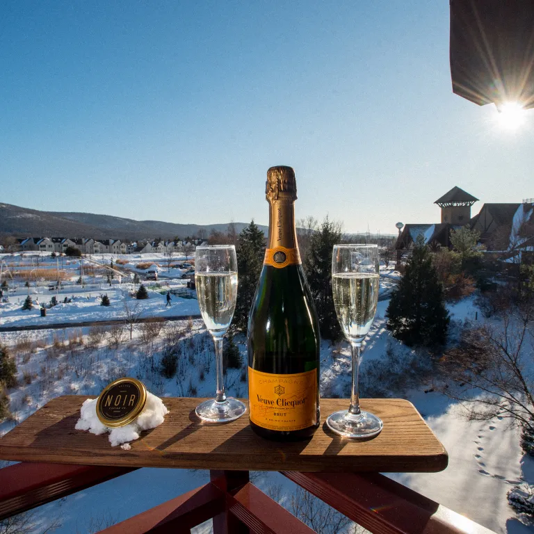 Glass of Champagne on a winter day at Grand Cascades Lodge