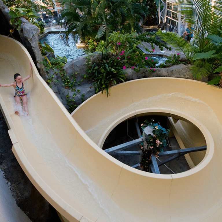 Young girl going down the Biosphere water slide