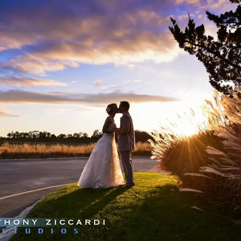 Beautiful wedding couple kissing at sunset