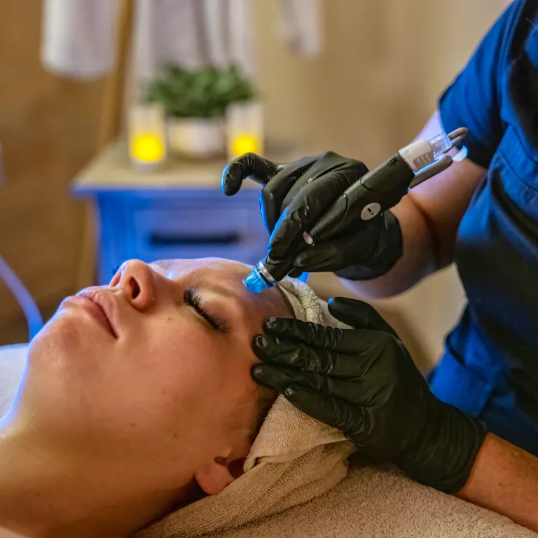 Woman receiving hydrafacial.