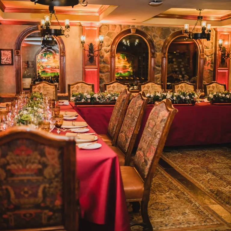 Long dinner tables set in Wine Cellar.