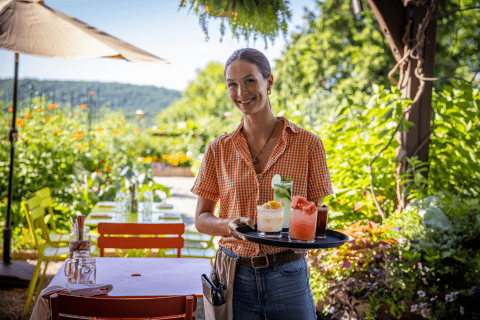 Chef's Garden server with tray of cocktails