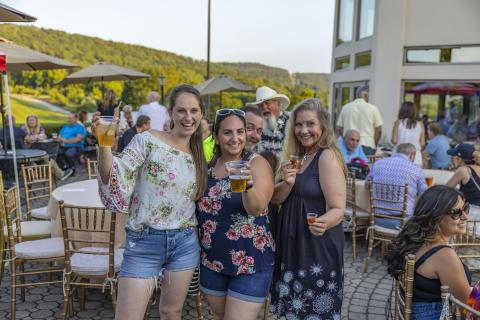 Women  holding beers at Black Bear bourbon and bbq.