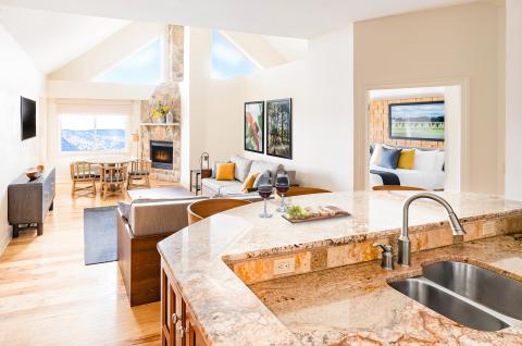 Kitchen sink and view of living room and fireplace in the 2-Bed 2 Bath Unique Cascades Sunset Lookout