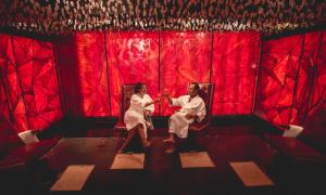 Couple sitting in Reflections Spa salt room cheersing champagne