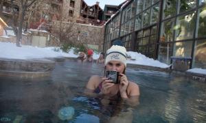 Woman enjoying hot chocolate in the snow pool