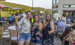 Women  holding beers at Black Bear bourbon and bbq.