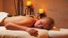 Woman laying on table with hot stones on her back during spa getaway. 