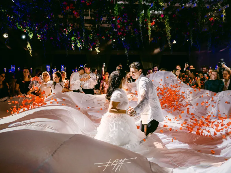 Bride and groom dancing surrounded by flowers at their wedding reception in Big Sky Pavillion.