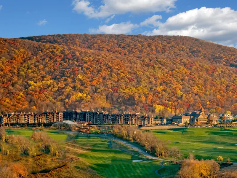 View of fall mountains behind Grand Cascades Lodge at Crystal Springs Resort in NJ