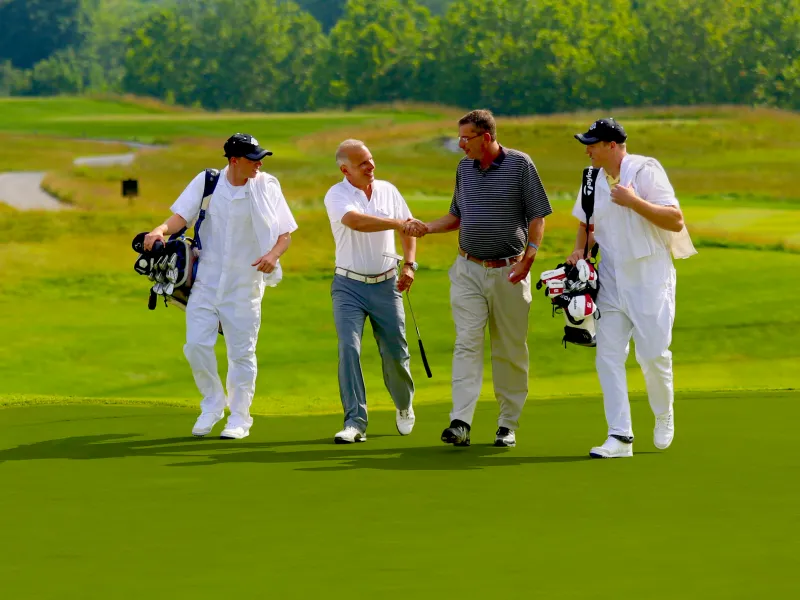 Golfers and caddies on a golf course at Crystal Springs Resort