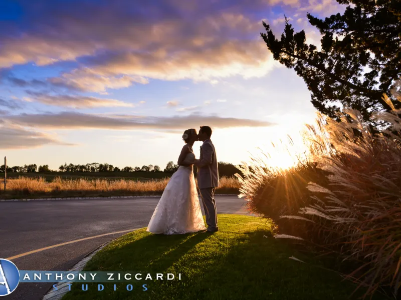 Bride and groom kissing with scenic sky background at Crystal Springs Resort in NJ