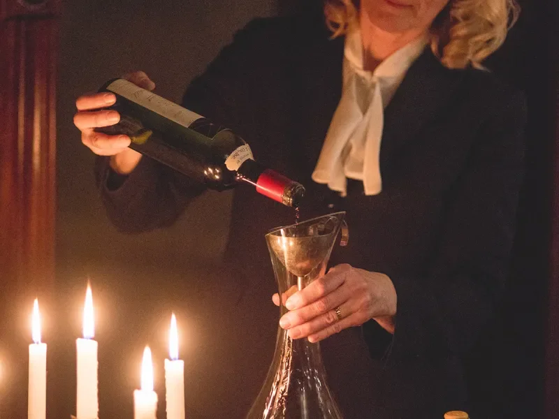 Susanne Wagner pouring wine into a decanter.