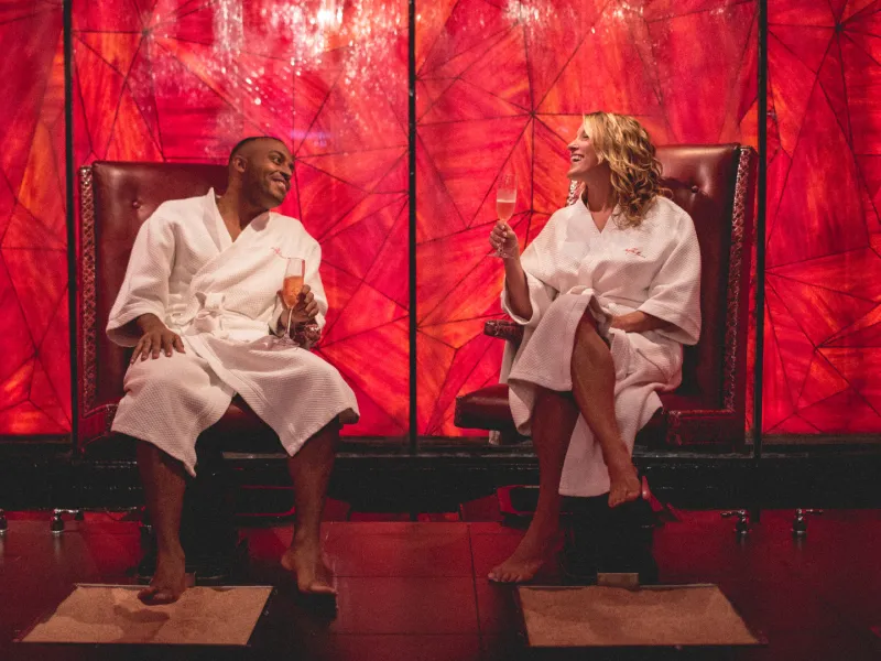 Couple in white robes sitting in salt room at Reflections Spa