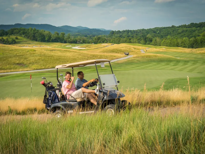 Guys riding on a golf cart at Ballyowen