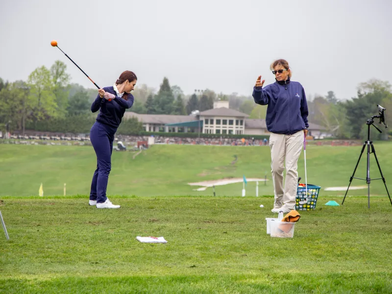 Girl learning to golf from Golf Pro at Leadbetter Academy