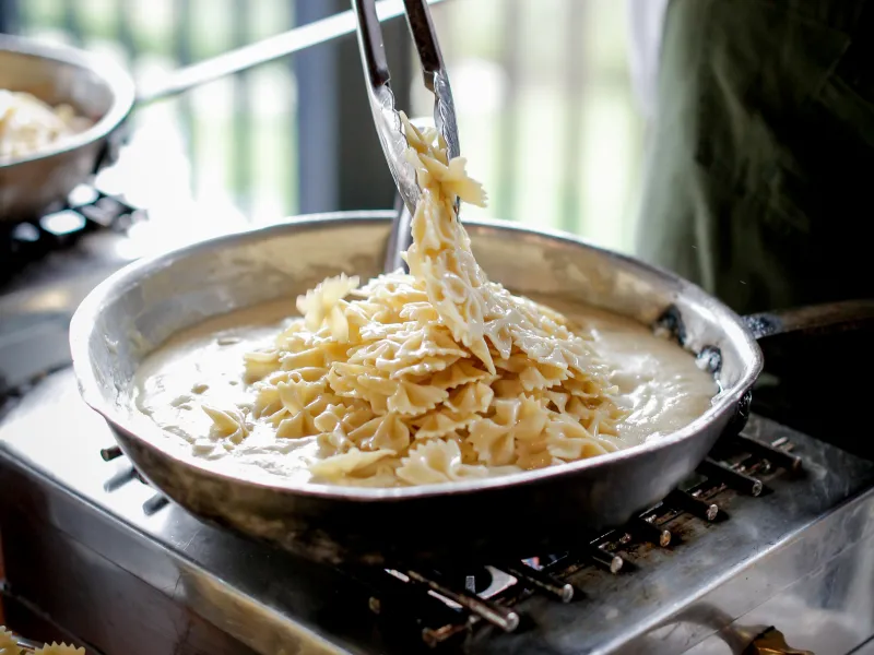 Chef cooking fresh pasta Alfredo 