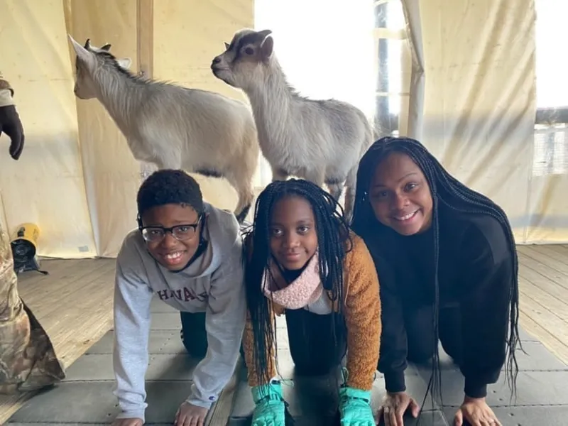 Group with goats on their backs