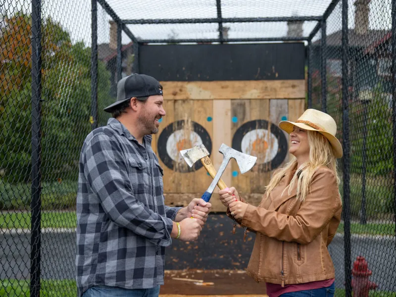 Couple doing axe throwing.