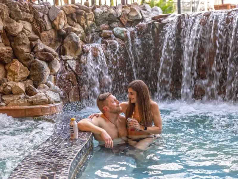 Couple enjoying drinks in the jacuzzi