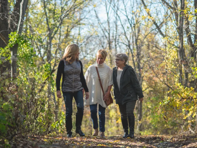 Women walking through a hiking trail in the forest