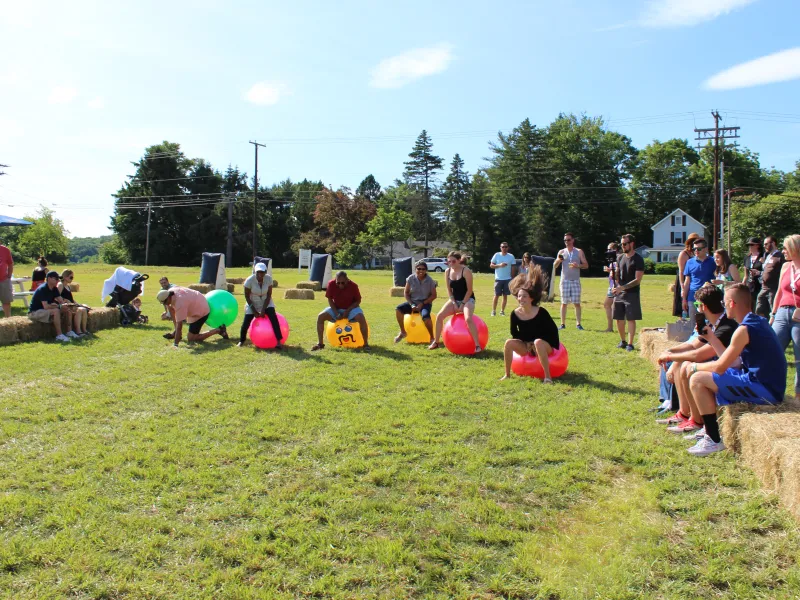 People racing on bouncy balls at the Hippity Hop race