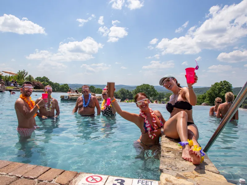 Group of people having luau at vista 180 pool party.