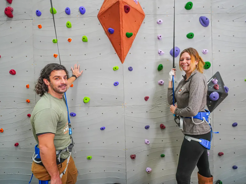 Two adults getting ready to rock climb.