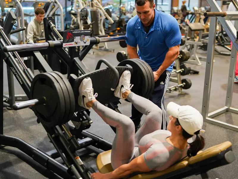 Woman working out using leg press at Minerals Sports Club.