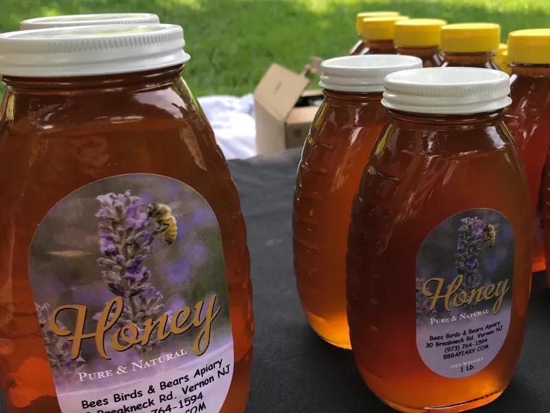 Local honey jars on table.